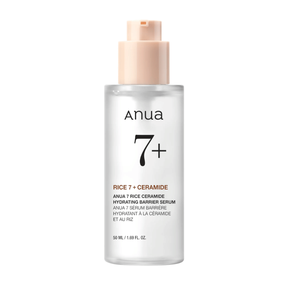 En flaske av "Anua 7+ Rice Ceramide Hydrating Barrier Serum" med et klart og minimalistisk design. Emballasjen er gjennomsiktig med en lyserosa pumpe, og inneholder 50 ml serum som er beriket med ris og ceramider for å fukte og styrke hudens barriere.