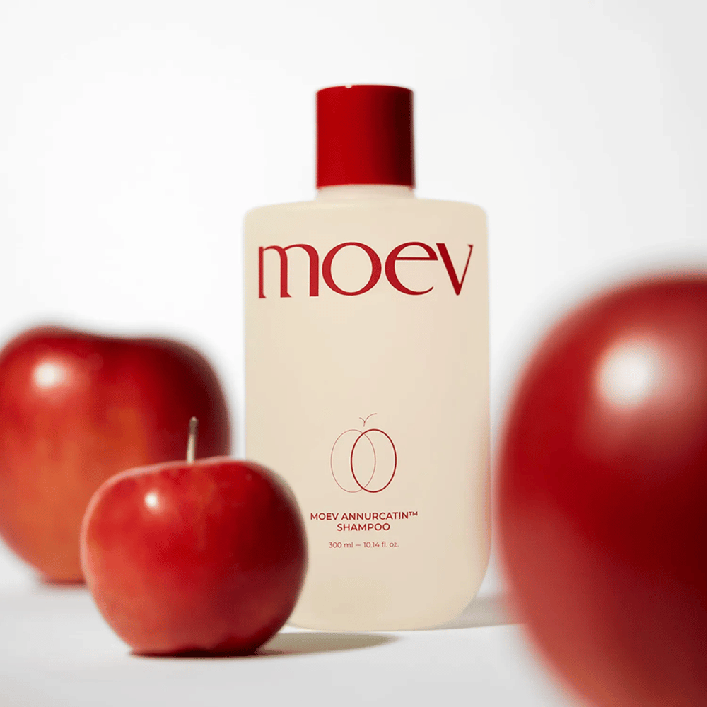 MOEV Annurcatin Shampoo plassert blant røde epler – inspirert av Annurca-eplets antioksidanter som gir sterkere, sunnere og mer glansfullt hår.