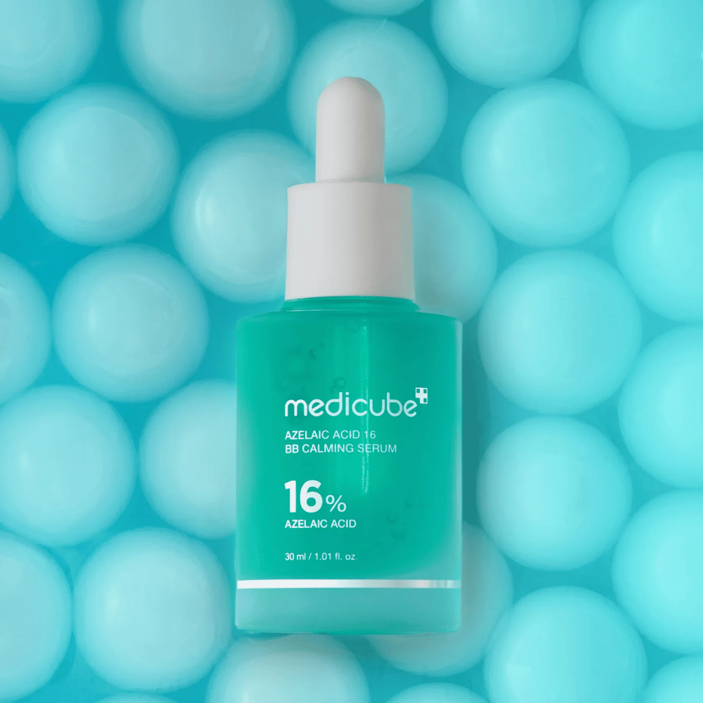 Kampanjebilde av Medicube Azelaic Acid 16 BB Calming Serum mot turkis bakgrunn med myke sfærer som symboliserer fuktighet, beroligende effekt og jevn hudstruktur.
