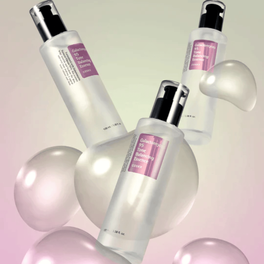 Tre flasker av COSRX Galactomyces 95 Tone Balancing Essence omgitt av lyse bobler. Hudforbedrende essens som jevner ut hudtonen og gir naturlig glans.