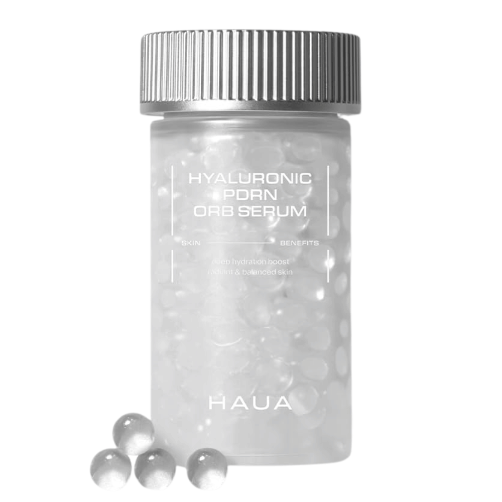 Produktbilde av HAUA Hyaluronic PDRN Orb Serum på hvit bakgrunn. Den transparente beholderen er fylt med serumkuler og fremhever produktets unike innkapslede formulering.