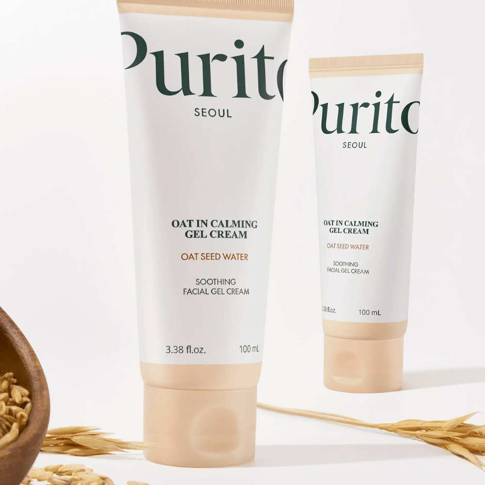 Purito Oat-In Calming Gel Cream i beige tube, plassert med havrekorn. Beroliger sensitiv hud med havrevann og lett geltekstur.