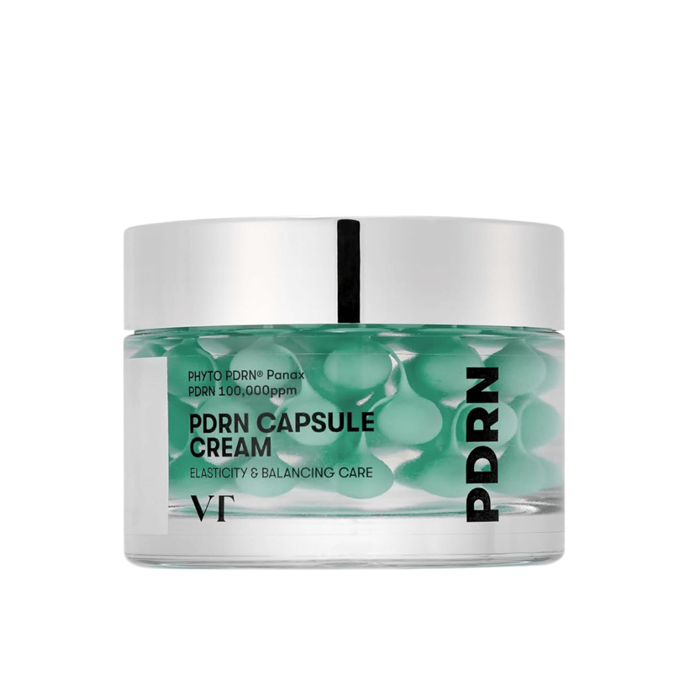 VT PDRN Capsule Cream i en gjennomsiktig krukke med sølvlokk. Innholdet består av grønne kapsler i en klar gel, og etiketten viser at kremen er ment for elastisitet og balanserende hudpleie.
