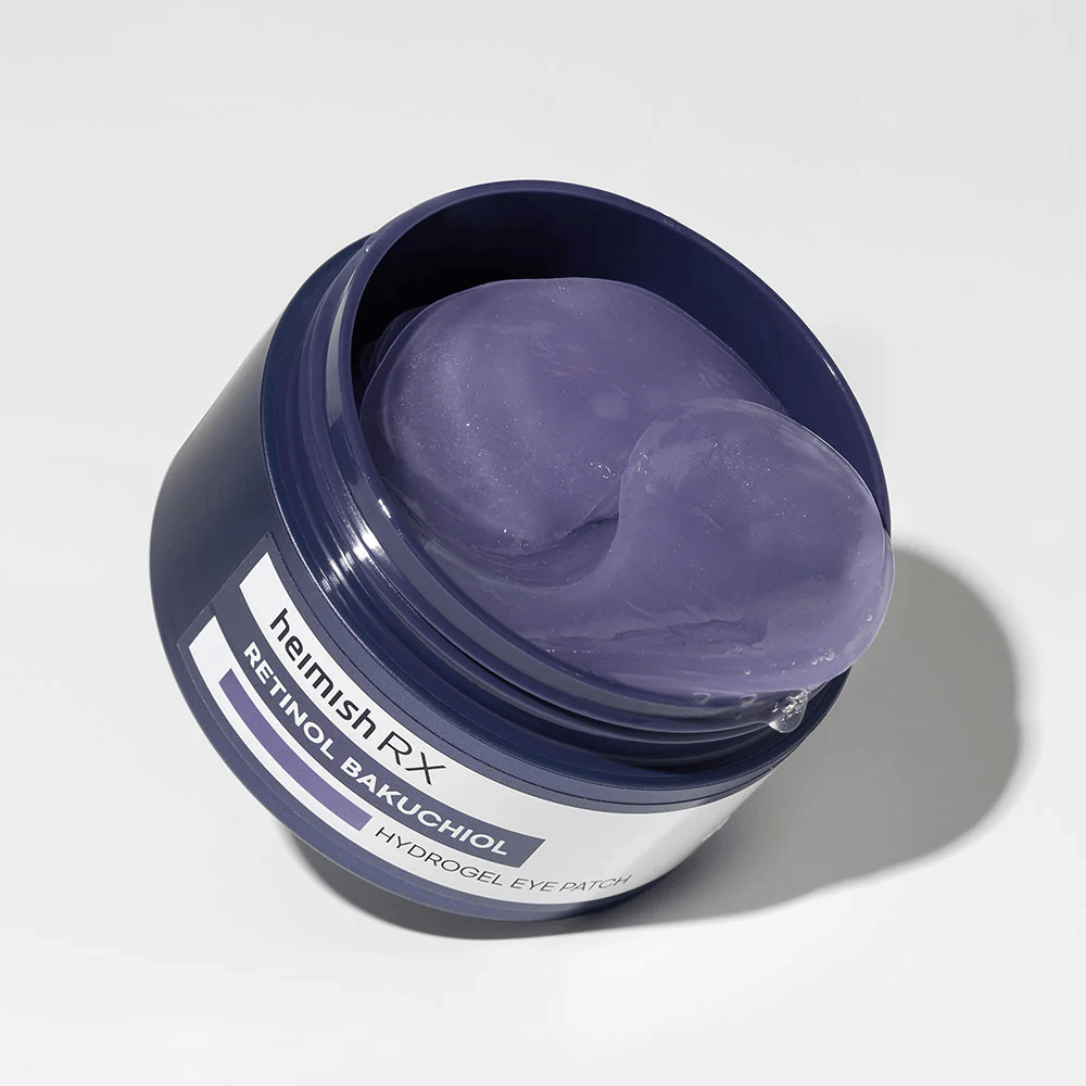 Heimish RX Retinol Bakuchiol Hydrogel Eye Patch i en mørkeblå boks med lilla hydrogel-øyeputer. Et produkt designet for å fukte og redusere fine linjer rundt øynene.