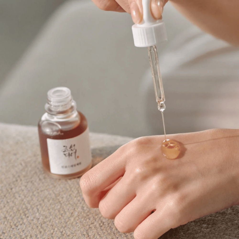 Pipette dråper Beauty of Joseon Revive Serum Ginseng + Snail Mucin på huden – koreansk serum for elastisitet og fuktighet.