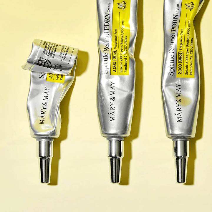 MARY & MAY Spicule Retinol PDRN Cream med synlig bruk i tube, viser kremens konsistens og rettet applikator for presis påføring på huden.